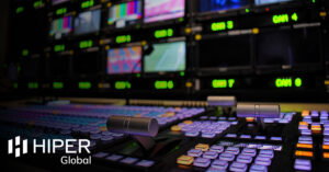 A wide shot of a vision mixing panel in a television gallery - including the HIPER Global logo