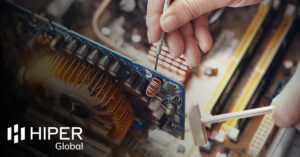 A technical engineer working on a motherboard - including the HIPER Global logo