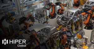 Automated robotic machinery on a car production line - including the HIPER Global logo