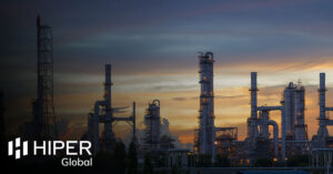 An oil pipeline facility at night - including the HIPER Global logo