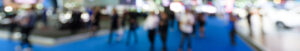 A blurred shot of people walking through a trade show