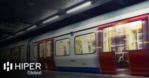 A passing train running on underground transportation infrastructure - including the HIPER Global logo